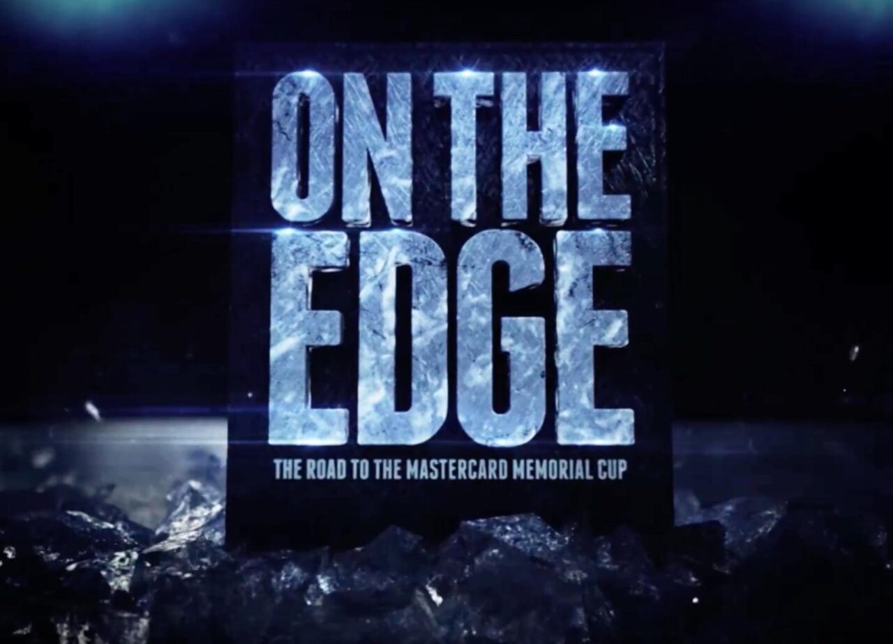 In a dark rink, shows a block of black ice with the title "On The Edge - The Road to the Mastercard Memorials Cup" surrounded on the.bottom by chipped ice.